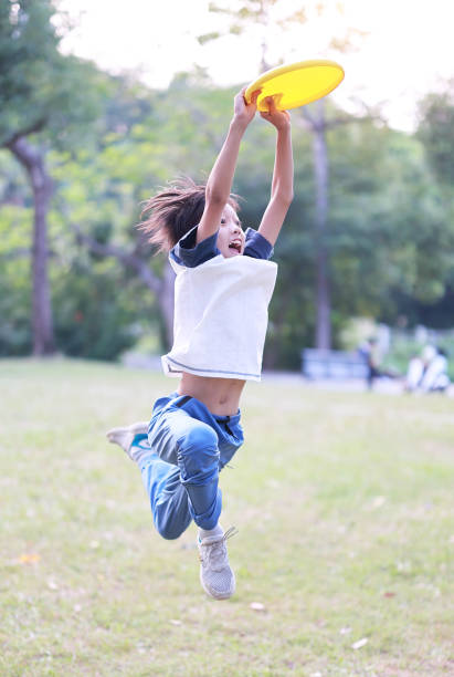 istock Little boy plays frisbee in park 1436331201