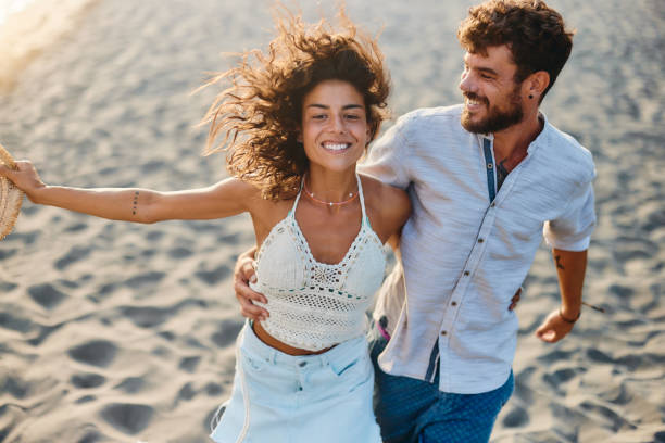 istock Happy couple running on the beach. 1436332247