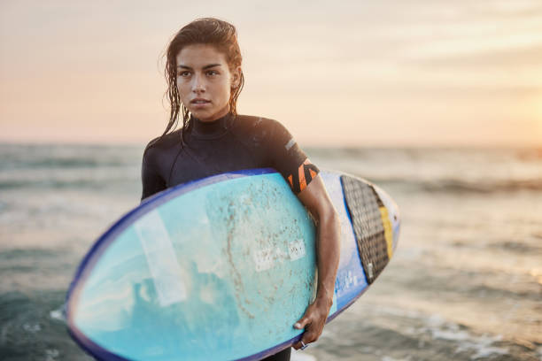istock Pensive female surfer on the beach at sunset. 1436332926