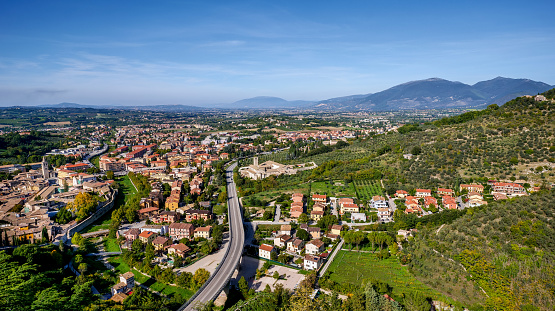 A beautiful wide view of the Umbrian Valley with the medieval town of Spoleto in the foreground. Towards the horizon the territories of the medieval cities of Foligno and Assisi extend, while on the right the Sibillini Mountains. In the center, the freeway of the Via Flaminia and near the ancient complex of the Monastery of San Ponziano, built in the 12th century in the Lombard style. Spoleto, one of the most visited medieval cities in Italy, hosts the Festival of the Two Worlds, a world-famous event that brings together hundreds of artists, musicians, classical dancers and opera singers every year. The Umbria region, considered the green lung of Italy for its wooded mountains, is characterized by a perfect integration between nature and the presence of man, in a context of environmental sustainability and healthy life. In addition to its immense artistic and historical heritage, Umbria is famous for its food and wine production and for the quality of the olive oil produced in these lands. Super wide angle image in 16:9 and high definition format.