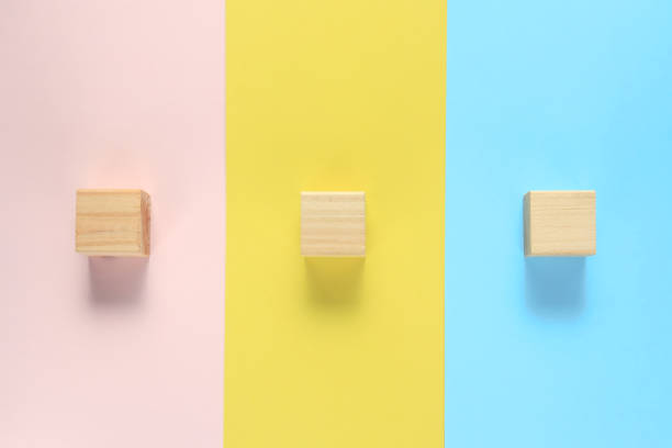 istock The building blocks are placed one by one on a pink, yellow, and blue background. 1436334654