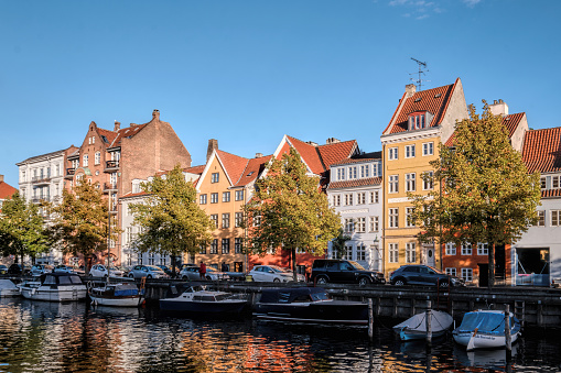 Copenhagen, Denmark - Sept 2022: Historical canal and waterfront houses with typical danish architecture in Christianshavn Neighborhood