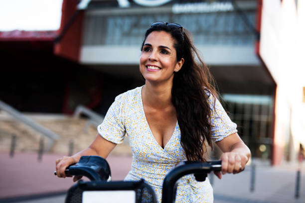 istock Beautiful girl using electric bicycle 1436336119