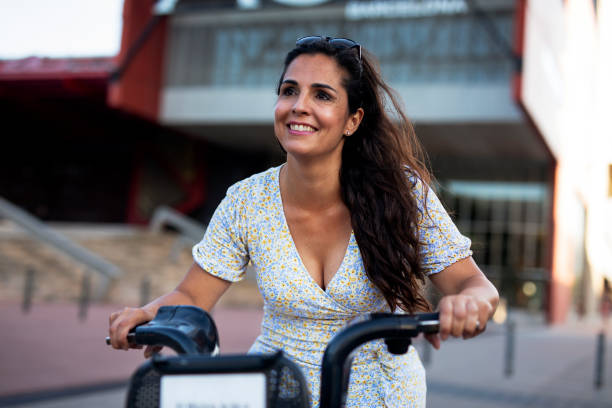 istock Beautiful girl using electric bicycle 1436336271