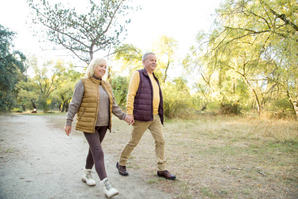 istock Couple holding hans while walking in the forest 1436336694