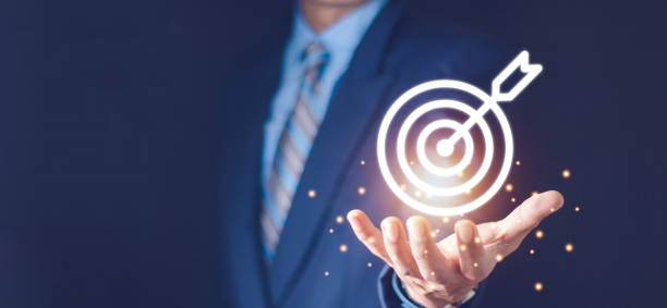 istock Businessman holding virtual dartboard and arrow with copy space for setup business objective target concept. 1436336713