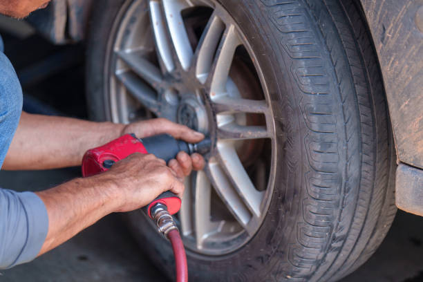 istock auto mechanic repairman changing wheel and tire in a workshop 1436339276