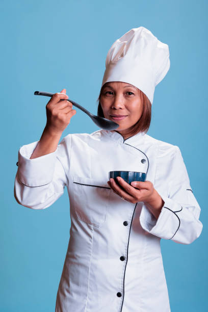 istock Confident positive cook holding kitchen bowl tasting prepared food meal 1436340807