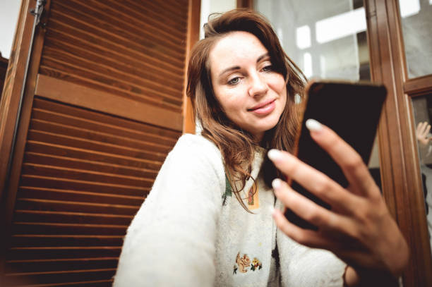 istock woman using smartphone at cozy home on terrace. 1436341039