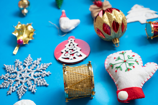 Christmas related objects and Christmas ornaments, gifts on blue background