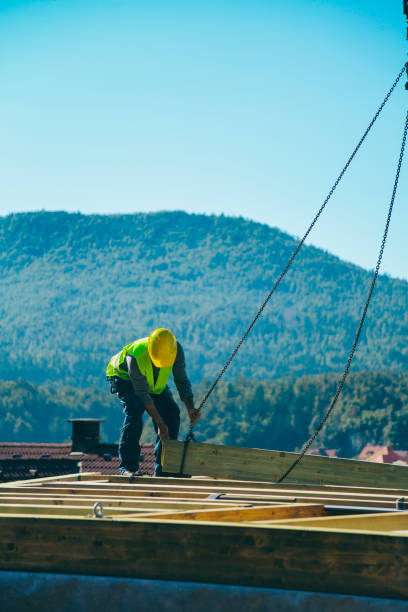 istock Construction worker standing on a wooden house construction site 1436345531