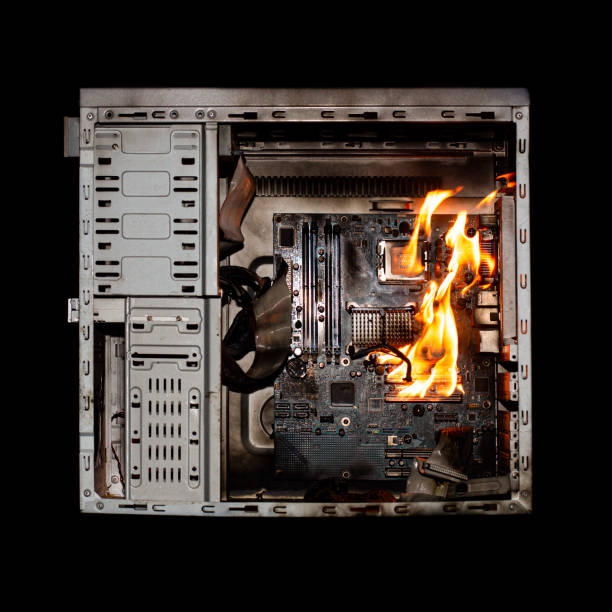 istock a burning system unit from a computer from a short circuit and a power surge on a black isolated background 1436346565