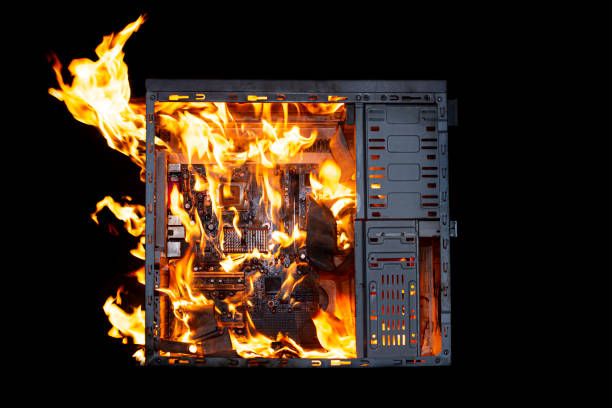 istock a burning system unit from a computer from a short circuit and a power surge on a black isolated background 1436346622