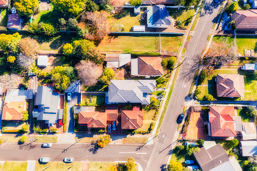 Residential suburbs of low-rise detached houses in Western Sydney city of Ryde - aerial top down view.