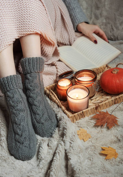 istock Girl covered with a blanket in knitted socks. 1436349317