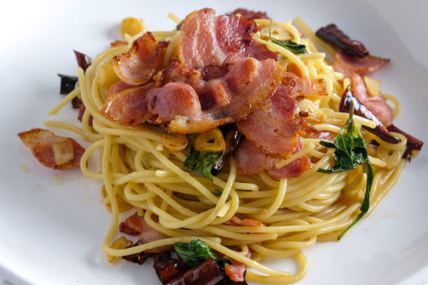 Stir-Fried Spaghetti With Dried Chili And Crispy Bacon on white dish.
