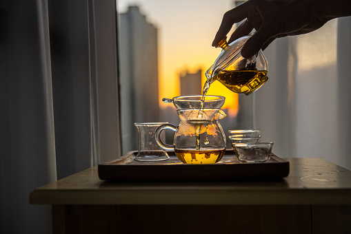 Tea pouring into a tea cup