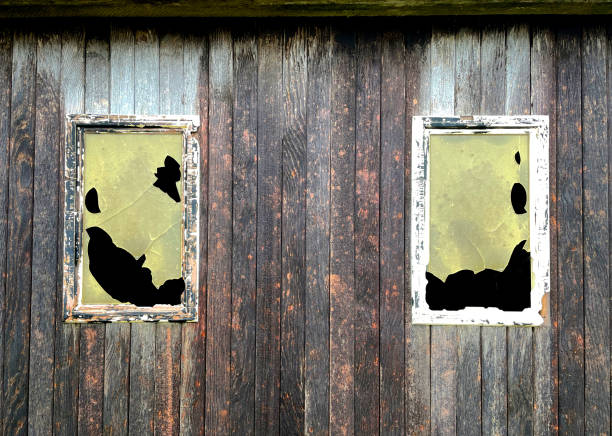Detail of an abandoned house with broken window.