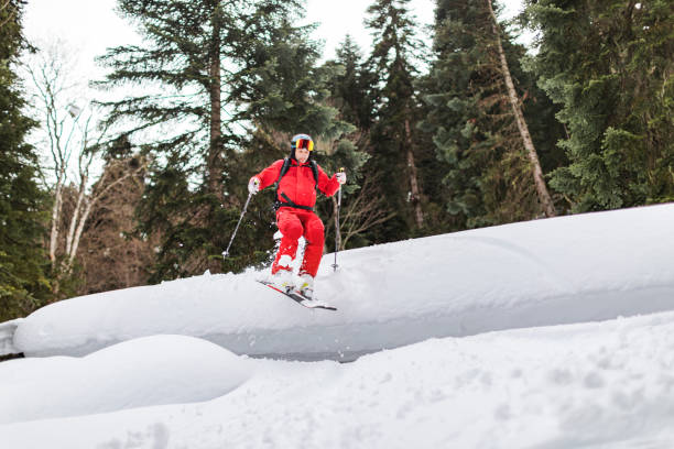 istock Young adult man skiing in forest 1436351796