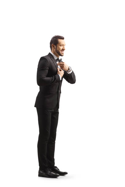 istock Full length profile shot of a young elegant man getting ready and fixing his bow tie 1436354936