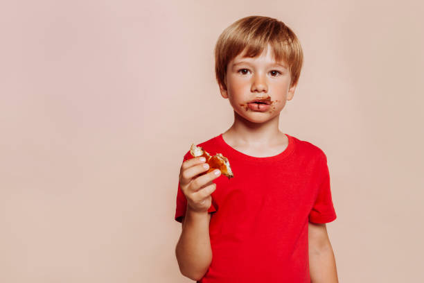 istock Little cute kid with chocolate on face and hands 1436355080