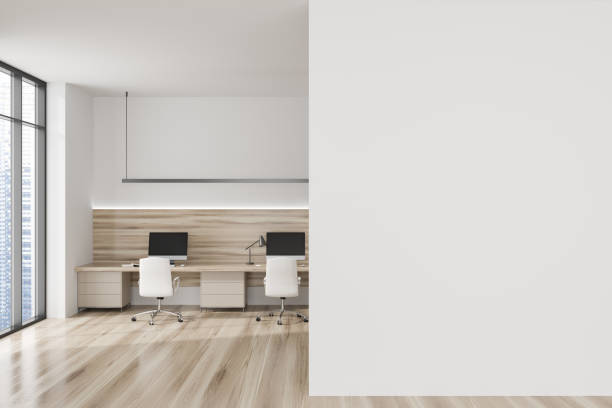 istock Light office interior with pc computer and armchairs on wooden floor. Mockup wall 1436358241