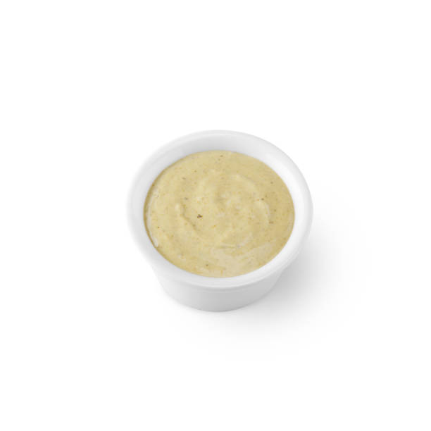 istock Yellow sauce in a bowl on a white background 1436358273