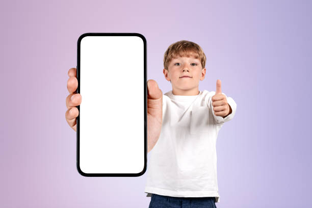 istock Boy wearing casual wear holding smartphone case with copy space 1436359024