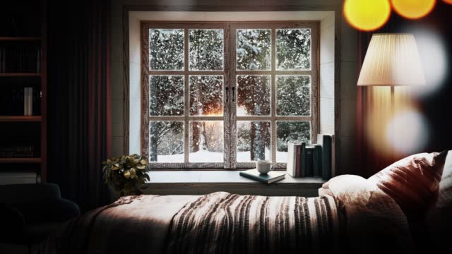 A snowy winter forest view looking out the window from a warm and comfortable bedroom
