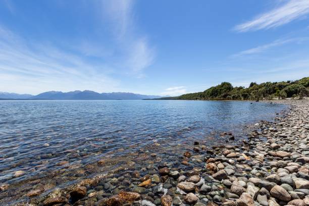 istock Beautiful rocky seashore with mountains in the distance 1436362203