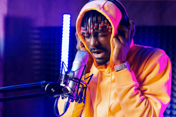istock Young African performer recording his new track in recording studio 1436363830