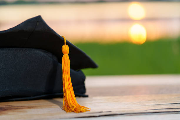 istock A black graduation cap and a certificate placed on wood desk 1436365930