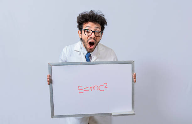 istock Scientist holds and points to a whiteboard with a mathematical formula. Scientist showing blackboard with mathematical equation, Physics professor holding whiteboard with a mathematical formula 1436366978
