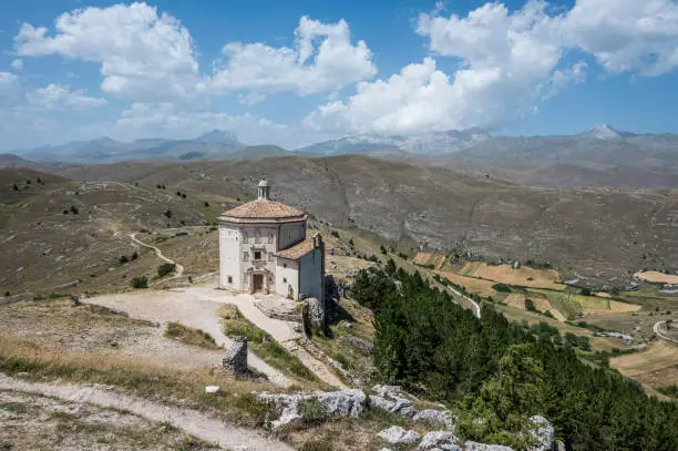 Photo of The church of Santa Maria della Pietà in Rocca Calascio with the beautiful Abruzzo mountains and hills in the background