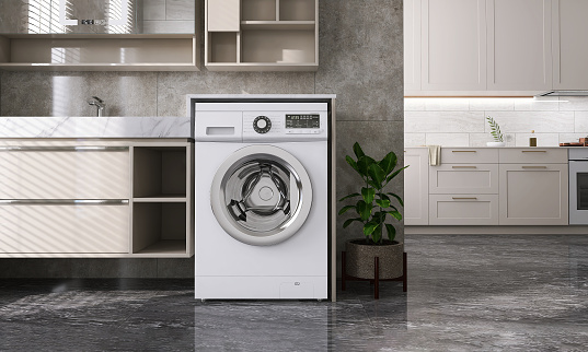 Modern and luxury design of beige laundry room with washing machine, counter, cabinet, shelf connected to kitchen on black granite tile floor with sunlight from window blinds for cleaning and washing product display