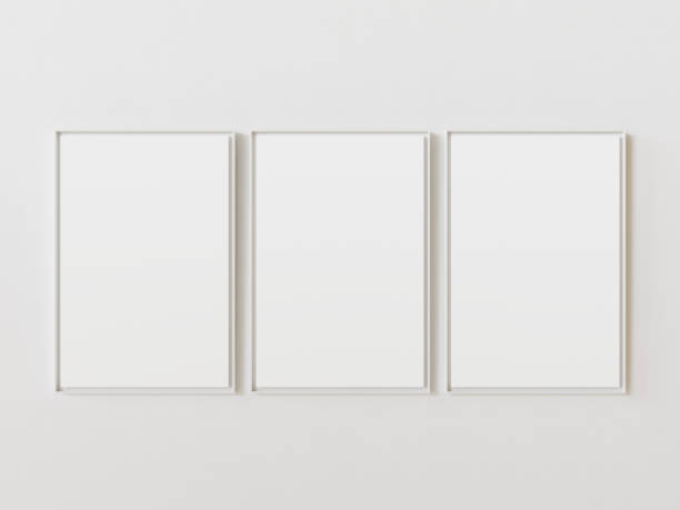 istock Three blank pictures hanging on white wall in row. White plastic shape border around. Template for your content. 3D illustration. 1436367877
