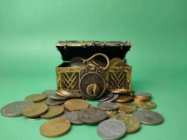 istock Treasure box with coins on a soft green background. 1436367952