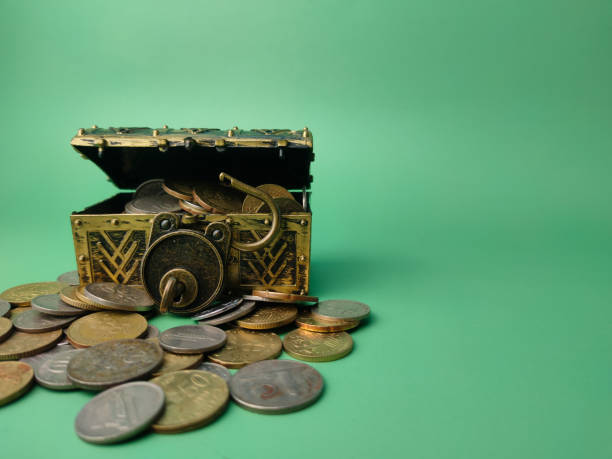 istock Treasure box with coins on a soft green background. 1436368384