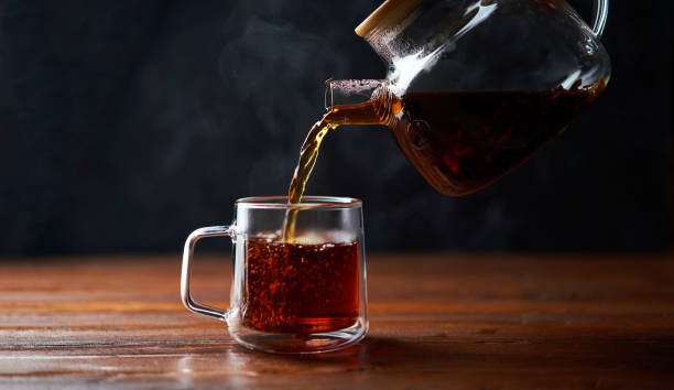 istock Tea poured from a teapot into a cup 1436369058