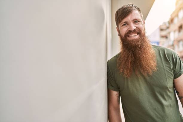 istock Young redhead man smiling confident standing at street 1436369556