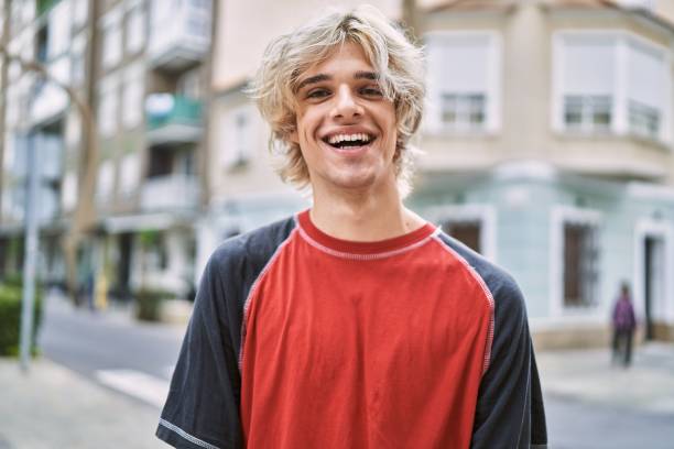istock Young blond man smiling confident standing at street 1436370153