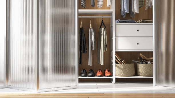 Modern and elegant design of walk in closet with neat, adjustable and organized shelf and man's clothes and folding reeded acrylic glass door with stainless steel frame Front view of modern and elegant design of walk in closet with neat , adjustable and organized shelf and man's luxury clothes, shirt and leather shoes, and folding reeded acrylic glass door with stainless steel frame walk in closet stock pictures, royalty-free photos & images