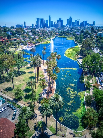 A vertical aerial view of the beautiful Echo Park Lake near the downtown Los Angeles skyline