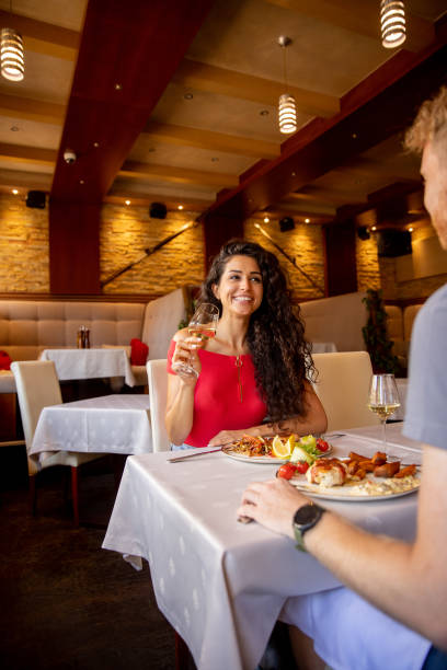 istock Young couple having lunch with white wine in the restaurant 1436371937