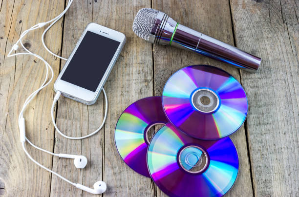 istock Dvd disks, musical microphone, smartphone with headphones 1436373674