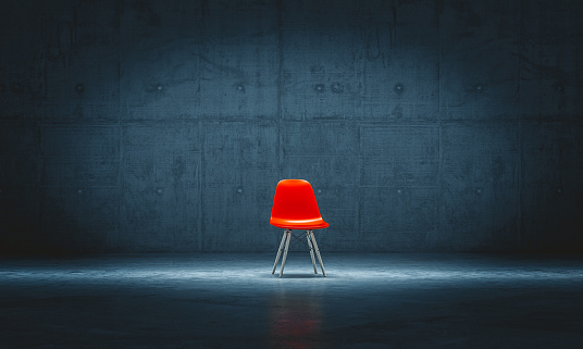 lonely red chair in a concrete room. 3d render