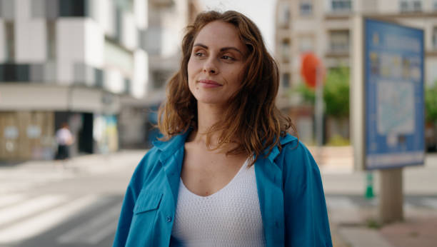 istock Young woman with relaxed expression standing at street 1436374157