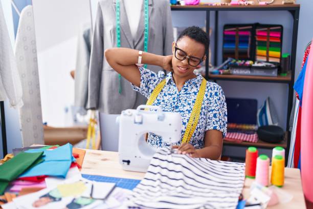 istock African american woman tailor stressed using sewing machine at tailor shop 1436374478