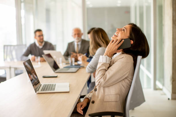istock Young woman using mobile phone in the office 1436375502