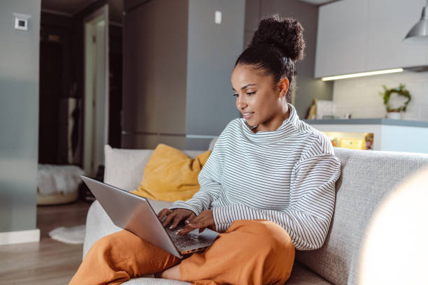 istock Beautiful woman working on a laptop at home 1436376052